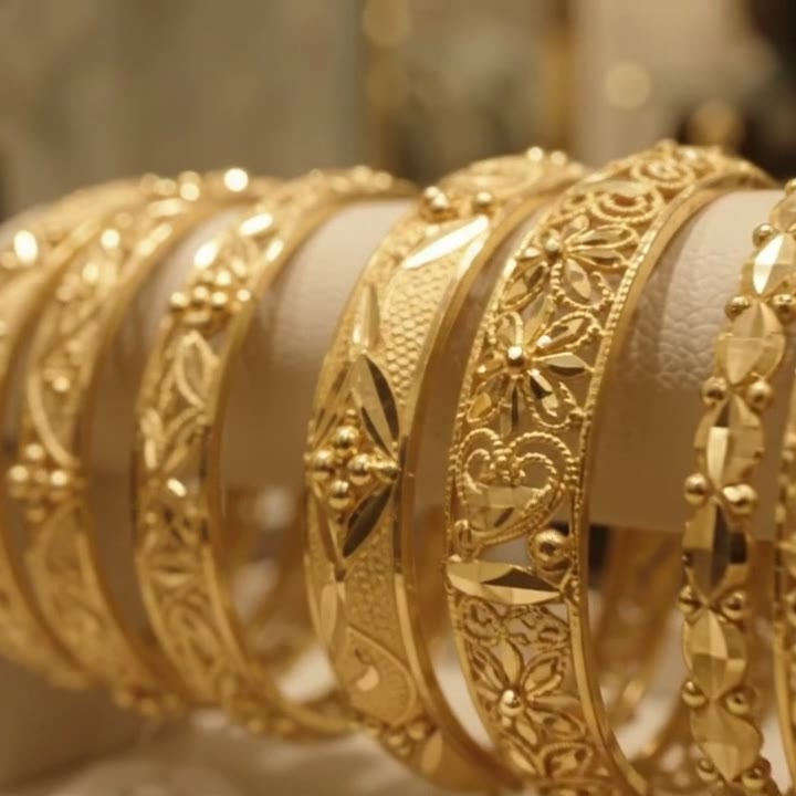 Stack of engraved gold bangles